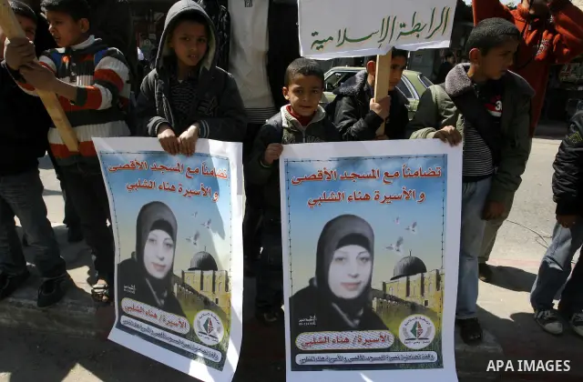 Palestinians demonstrate in solidarity with Hana'a Shalabi during a protest in Rafah, southern Gaza Strip on March 7, 2012. Shalabi, released by Israel in a prisoner swap last year but re-arrested earlier this month and...