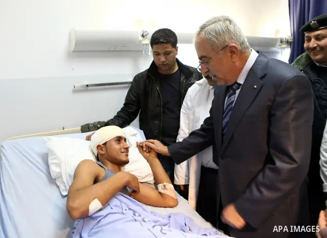 Palestinian Prime Minister Salam Fayyad, visits a hospital in the West Bank city of Ramallah, March 07, 2012. Photo by Mustafa Abu Dayah