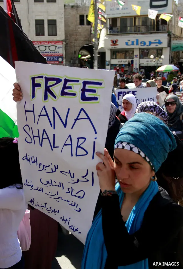 Palestinian women carry banners as they mark International Women's Day in solidarity with Hana Shalabi, a Palestinian prisoner jailed in Israel and who has been on hunger strike for 22 days, in the West Bank in Nablus, T...