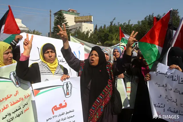 A Palestinian woman hold a poster during a protest calling for the release of Hana Shalabi, a female Palestinian prisoner jailed in Israel who has been on hunger strike for 22 days, outside the Red Cross building in Gaza...