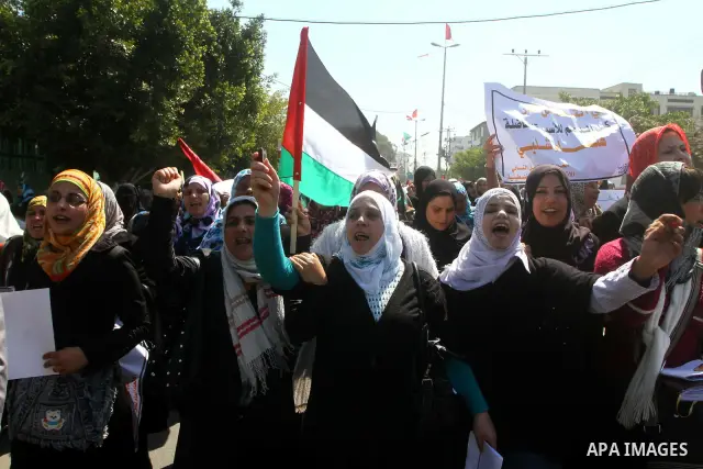 A Palestinian woman hold a poster during a protest calling for the release of Hana Shalabi, a female Palestinian prisoner jailed in Israel who has been on hunger strike for 22 days, outside the Red Cross building in Gaza...