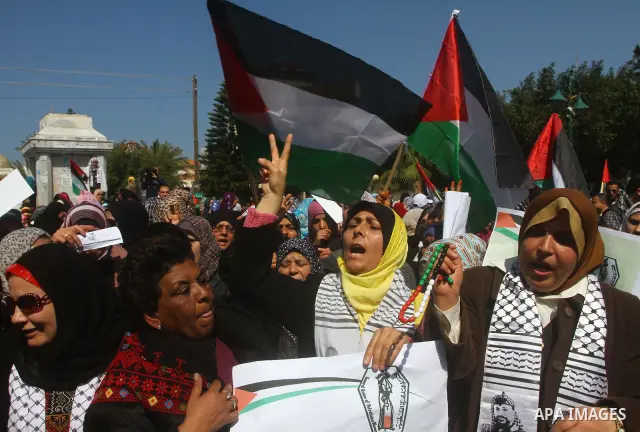 A Palestinian woman hold a poster during a protest calling for the release of Hana Shalabi, a female Palestinian prisoner jailed in Israel who has been on hunger strike for 22 days, outside the Red Cross building in Gaza...
