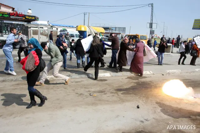 Palestinian women take part in a rally to mark International Women's Day and to show their solidarity with female Palestinian detainee Hana Shalabi, who is on hunger strike, at Qalandia checkpoint near the West Bank city...