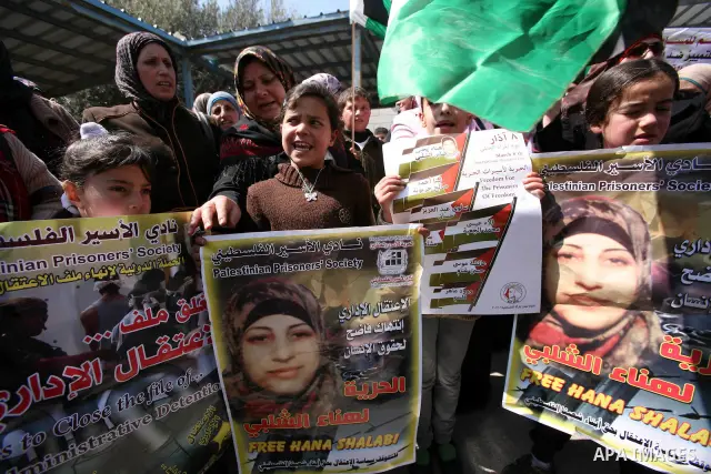 Palestinians hold portraits of jailed compatriots as they join a protest in solidarity with Hana Shalabi, a female Palestinian prisoner jailed in Israel who has been on hunger strike for 19 days, in the West Bank city of...
