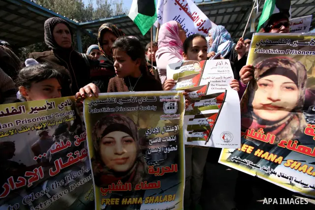 Palestinians hold portraits of jailed compatriots as they join a protest in solidarity with Hana Shalabi, a female Palestinian prisoner jailed in Israel who has been on hunger strike for 19 days, in the West Bank city of...