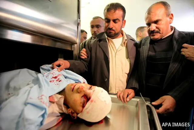 Relatives contemplate the dead body of Zakarya Abu Eram, who was shot dead by an Israeli soldier during an Israeli military operation in the village of Yatta, south of the West Bank town of Hebron, 08 March 2012. An Isra...