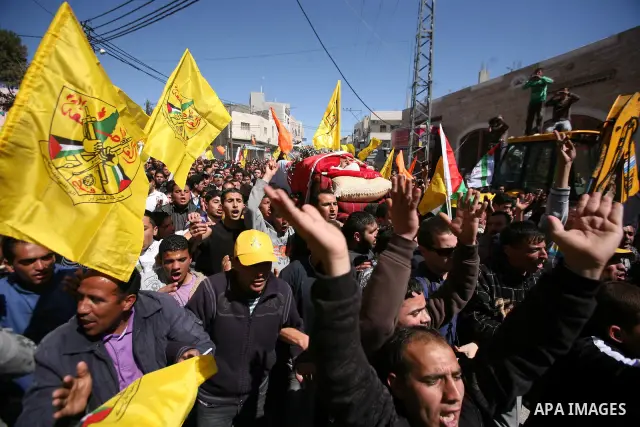 Palestinians carry the body of Zakariya Abu Eram during his funeral in the West Bank town of Yatta, near Hebron, Friday, March 9, 2012. According to the Israeli military, a Palestinian stabbed an Israeli soldier in the n...