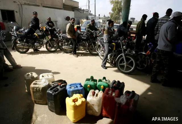 Palestinians wait to fill containers with fuel at a petrol station in Khan Younis in the southern Gaza Strip March 8, 2012. Palestinian Islamist group Hamas faces growing discontent in its Gaza stronghold because of rene...