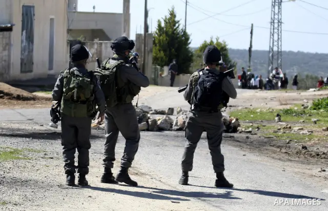 Israeli soldiers fire tear gas canisters at Palestinian protestors during a demonstration against the expropriation of Palestinian land by Israel in the village of Kafr Qaddum, near Nablus in the occupied West Bank on Ma...