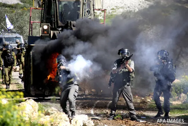Israeli soldiers fire tear gas canisters at Palestinian protestors during a demonstration against the expropriation of Palestinian land by Israel in the village of Kafr Qaddum, near Nablus in the occupied West Bank on Ma...