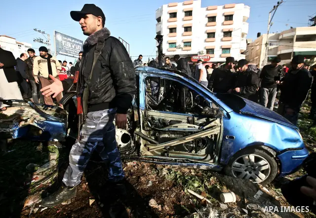 Palestinain policemen inspect the remains of a vehicle after it exploded in Gaza City March 9, 2012. Israel killed the leader of a Palestinian militant faction on Friday in a targeted attack on the car in the Gaza Strip,...