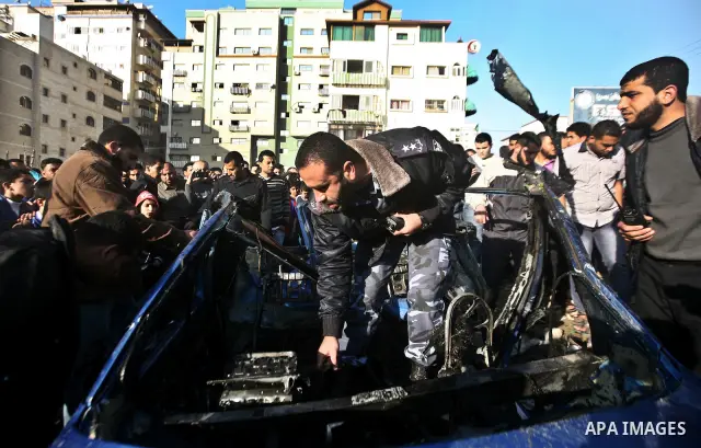 Palestinain policemen inspect the remains of a vehicle after it exploded in Gaza City March 9, 2012. Israel killed the leader of a Palestinian militant faction on Friday in a targeted attack on the car in the Gaza Strip,...