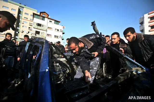 Palestinain policemen inspect the remains of a vehicle after it exploded in Gaza City March 9, 2012. Israel killed the leader of a Palestinian militant faction on Friday in a targeted attack on the car in the Gaza Strip,...