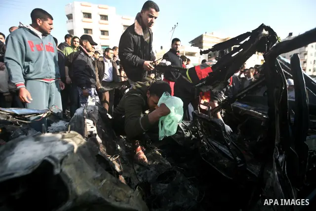 Palestinain policemen inspect the remains of a vehicle after it exploded in Gaza City March 9, 2012. Israel killed the leader of a Palestinian militant faction on Friday in a targeted attack on the car in the Gaza Strip,...