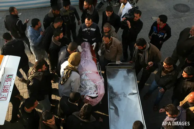 Palestinian carry the body of Zuhair al-Qaissi, a commanderl of the armed wing of the Popular Resistance Committees (PRC) in Gaza City, Friday, March 9, 2012. An Israeli airstrike killed top Palestinian militant commande...