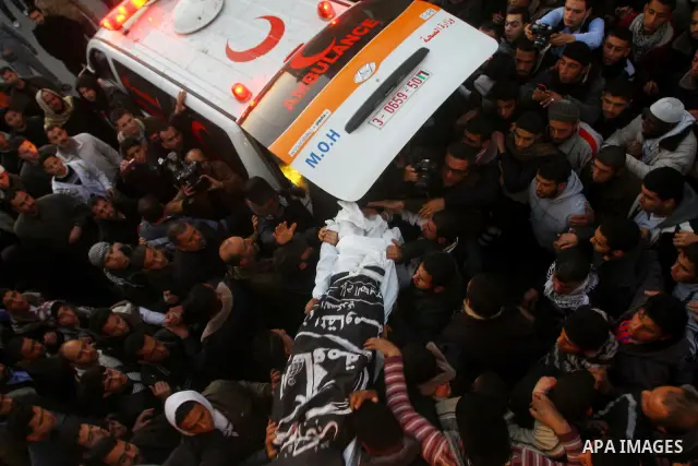 Palestinian carry the body of Zuhair al-Qaissi, a commander of the armed wing of the Popular Resistance Committees (PRC) in Gaza City, Friday, March 9, 2012. An Israeli airstrike killed top Palestinian militant commander...