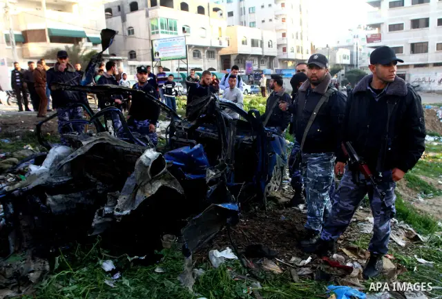 Palestinain policemen inspect the remains of a vehicle after it exploded in Gaza City March 9, 2012. Israel killed the leader of a Palestinian militant faction on Friday in a targeted attack on the car in the Gaza Strip,...