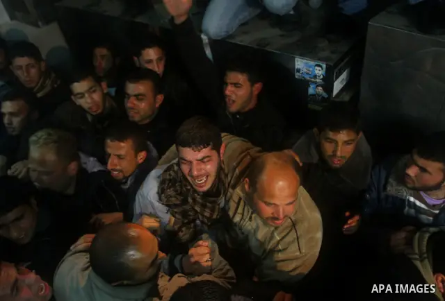 Relatives of a man killed in an Israeli airstrike mourn at a morgue in Gaza City, Friday, March 9, 2012. The Israeli military said in a statement that it targeted two rocket launching positions in the Gaza Strip Friday....