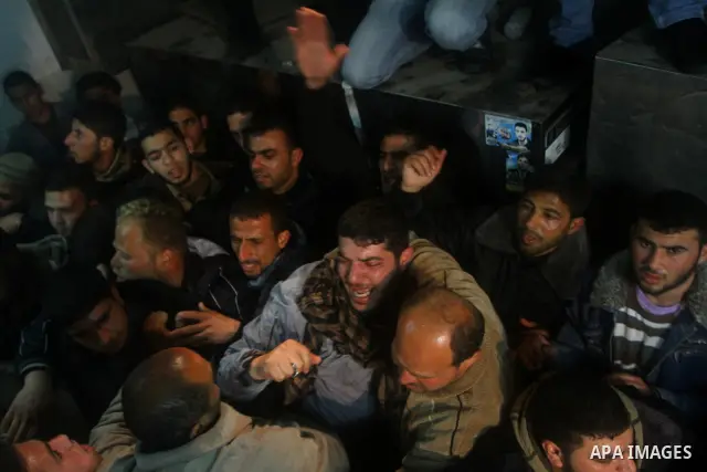 Relatives of a man killed in an Israeli airstrike mourn at a morgue in Gaza City, Friday, March 9, 2012. The Israeli military said in a statement that it targeted two rocket launching positions in the Gaza Strip Friday....
