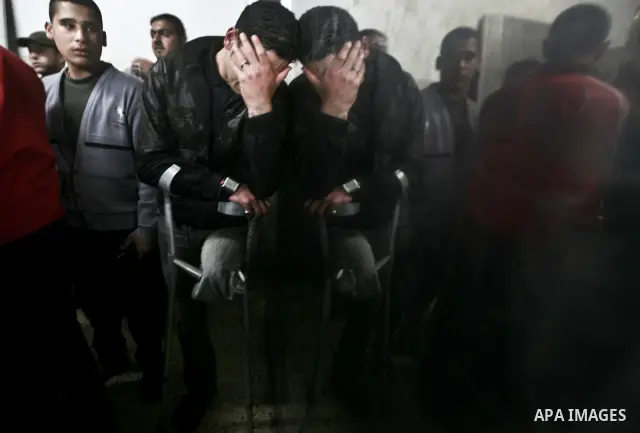 A Palestinian man mourns in a hospital after two militants of the Al Quds Brigades, the military arm of Islamic Jihad, were killed in a second Israeli air strike in Gaza City on March 9, 2012, bringing the number of Pale...