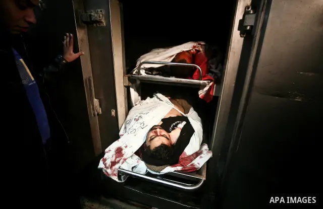 Palestinian mourn over the body islamic Jehad militant Hazem Kerekeaa in the al-Shifa hospital morgue on March 9, 2012, bringing the number of Palestinians killed in a day of cross-boarder fighting to four after a second...