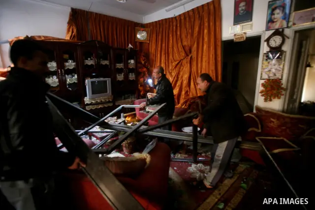 Palestinians inspect damage in their house in Al Shijaia Neighborhood in Gaza city, after an Israeli air strike in Gaza City on 10 March 2012, bringing the number of Palestinians killed in a day of cross-border fighting...