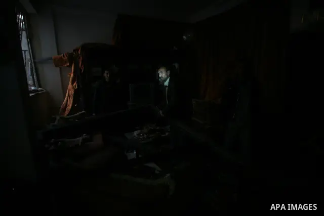 Palestinians inspect damage in their house in Al Shijaia Neighborhood in Gaza city, after an Israeli air strike in Gaza City on 10 March 2012, bringing the number of Palestinians killed in a day of cross-border fighting...