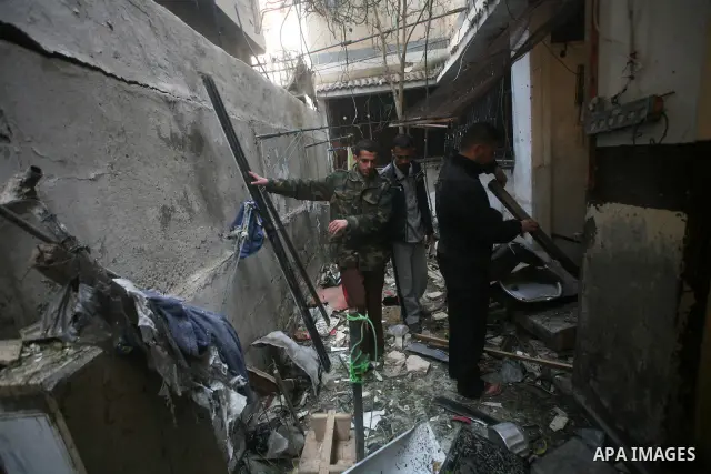 Palestinians inspect damage in their house in Al Shijaia Neighborhood in Gaza city, after an Israeli air strike in Gaza City on 10 March 2012, bringing the number of Palestinians killed in a day of cross-border fighting...