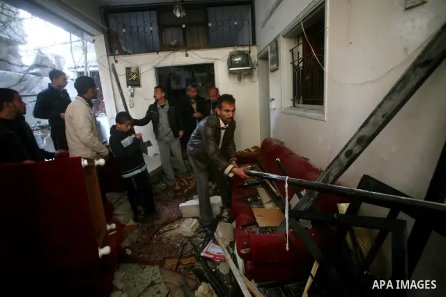 Palestinians inspect damage in their house in Al Shijaia Neighborhood in Gaza city, after an Israeli air strike in Gaza City on 10 March 2012, bringing the number of Palestinians killed in a day of cross-border fighting...