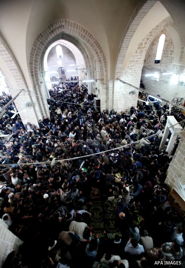 Palestinians pray near the bodies of Islamic Jihad militants during their funeral in Gaza March 10, 2012. Israel killed two more Gaza militants on Saturday, raising the death toll in two days of violence to 12 and dozens...