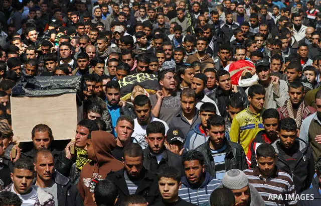 Palestinian mourners carry the bodies of seven Islamic Jihad militants (not all seen in picture), who were killed in Israeli air strikes, during their funeral in Gaza City on March 10, 2012. Twelve Palestinian fighters w...