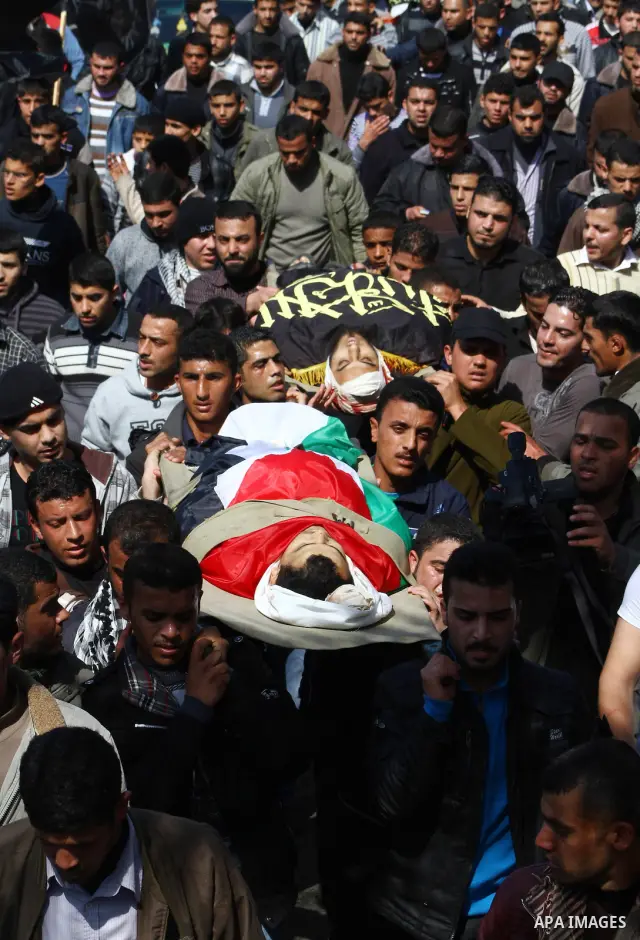 Palestinian mourners carry the bodies of seven Islamic Jihad militants (not all seen in picture), who were killed in Israeli air strikes, during their funeral in Gaza City on March 10, 2012. Twelve Palestinian fighters w...