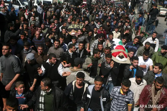 Palestinian mourners carry the bodies of seven Islamic Jihad militants (not all seen in picture), who were killed in Israeli air strikes, during their funeral in Gaza City on March 10, 2012. Twelve Palestinian fighters w...