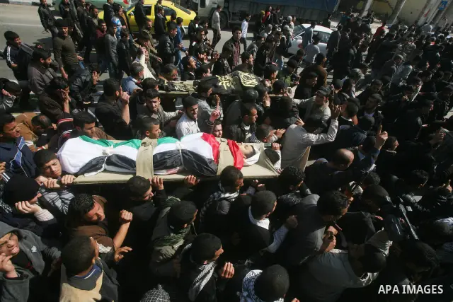Palestinian mourners carry the bodies of seven Islamic Jihad militants (not all seen in picture), who were killed in Israeli air strikes, during their funeral in Gaza City on March 10, 2012. Twelve Palestinian fighters w...