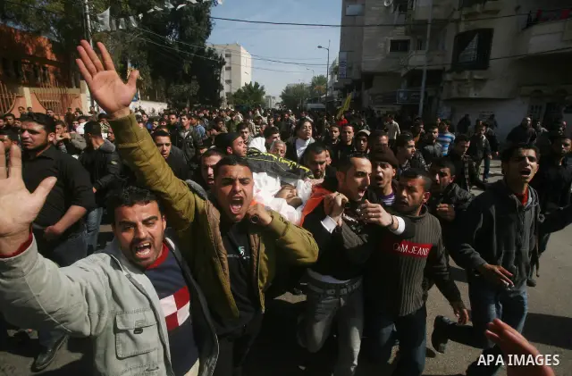 Palestinian mourners carry the bodies of seven Islamic Jihad militants (not all seen in picture), who were killed in Israeli air strikes, during their funeral in Gaza City on March 10, 2012. Twelve Palestinian fighters w...