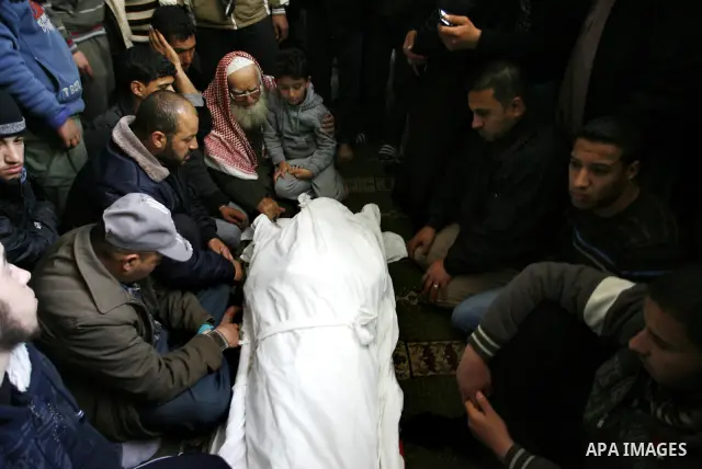 Palestinian relatives gather around the body of Popular Resistance Committees secretary-general Zuhir al-Qaisi's covered body at Al Awda Mosque, in Rafah. Fourteen Palestinian were killed and at least 20 people wounded i...