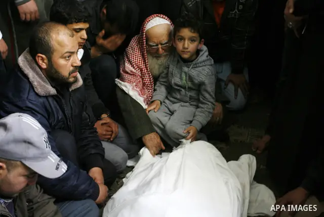 Palestinian relatives gather around the body of Popular Resistance Committees secretary-general Zuhir al-Qaisi's covered body at Al Awda Mosque, in Rafah. Fourteen Palestinian were killed and at least 20 people wounded i...