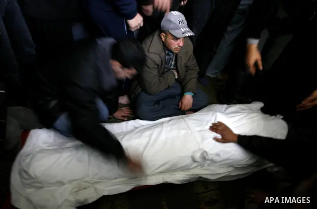 Palestinian relatives gather around the body of Popular Resistance Committees secretary-general Zuhir al-Qaisi's covered body at Al Awda Mosque, in Rafah. Fourteen Palestinian were killed and at least 20 people wounded i...