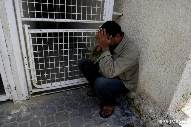 A Palestinian man react at a hospital following an Israeli air strike in Khan Younis in the southern Gaza Strip March 10, 2012. Israel killed four Gaza militants on Saturday as violence sparked by the death of a militant...