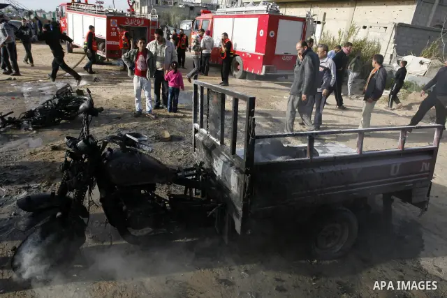Palestinians inspect the damage of a motorcycle bombing executed by an Israeli airstrike in Rafah, southern Gaza Strip, Saturday, March 10, 2012. The airstrike killed Popular Resistance Committees militant Mahdi Abu Shaw...