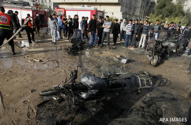 Palestinians inspect the damage of a motorcycle bombing executed by an Israeli airstrike in Rafah, southern Gaza Strip, Saturday, March 10, 2012. The airstrike killed Popular Resistance Committees militant Mahdi Abu Shaw...