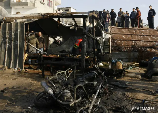 Palestinians inspect the damage of a motorcycle bombing executed by an Israeli airstrike in Rafah, southern Gaza Strip, Saturday, March 10, 2012. The airstrike killed Popular Resistance Committees militant Mahdi Abu Shaw...