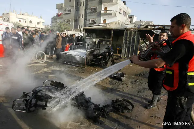 Palestinian Firefighters tries to extinguish a fire after an Israeli airstrike in Rafah, southern Gaza Strip, Saturday, March 10, 2012. The airstrike killed Popular Resistance Committees militant Mahdi Abu Shawesh. Despi...