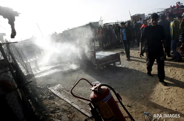 Palestinians inspect the damage of a motorcycle bombing executed by an Israeli airstrike in Rafah, southern Gaza Strip, Saturday, March 10, 2012. The airstrike killed Popular Resistance Committees militant Mahdi Abu Shaw...