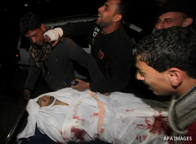 Relatives of Ahmed salem, 22-year-old, look at his body in the morgue of Al-Shifa hospital in Gaza City, on March 11, 2012, following a fresh Israeli air raid, bringing the death toll from strikes since March 10 to 17 an...