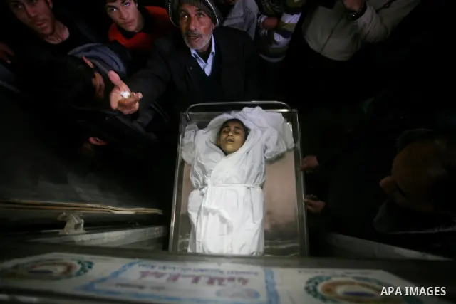 Relatives of Ayoub Assalya, 12-year-old, look at his body in the morgue of Kamal Edwan hospital in Beit Lahia in the northern Gaza Strip, on March 11, 2012, following a fresh Israeli air raid, bringing the death toll fro...