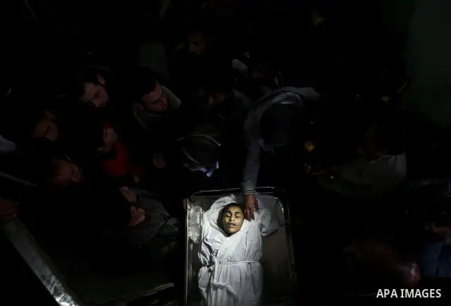 The body of Palestinian boy Ayoub Asalya, 12-year-old, lies in the morgue of Kamal Edwan hospital in Beit Lahia in the northern Gaza Strip, on March 11, 2012, following a fresh Israeli air raid, bringing the death toll f...