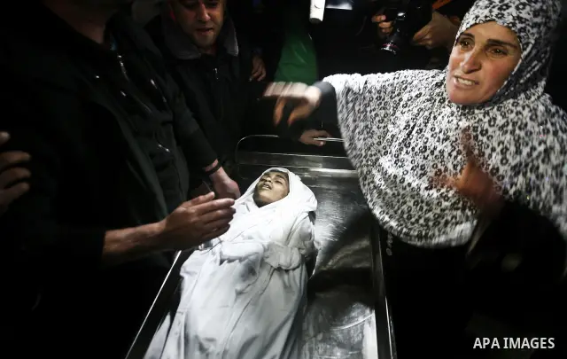The mother of Ayoub Asalya, 12-year-old, bids fare well to her son in the morgue of Kamal Edwan hospital in Beit Lahia in the northern Gaza Strip, on March 11, 2012, following a fresh Israeli air raid, bringing the death...
