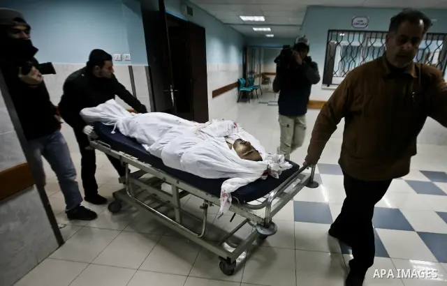 Relatives of Ahmed salem, 22-year-old, look at his body in the morgue of Al-Shifa hospital in Gaza City, on March 11, 2012, following a fresh Israeli air raid, bringing the death toll from strikes since March 10 to 17 an...
