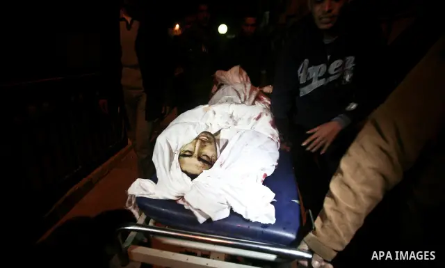 Relatives of Ahmed salem, 22-year-old, look at his body in the morgue of Al-Shifa hospital in Gaza City, on March 11, 2012, following a fresh Israeli air raid, bringing the death toll from strikes since March 10 to 17 an...